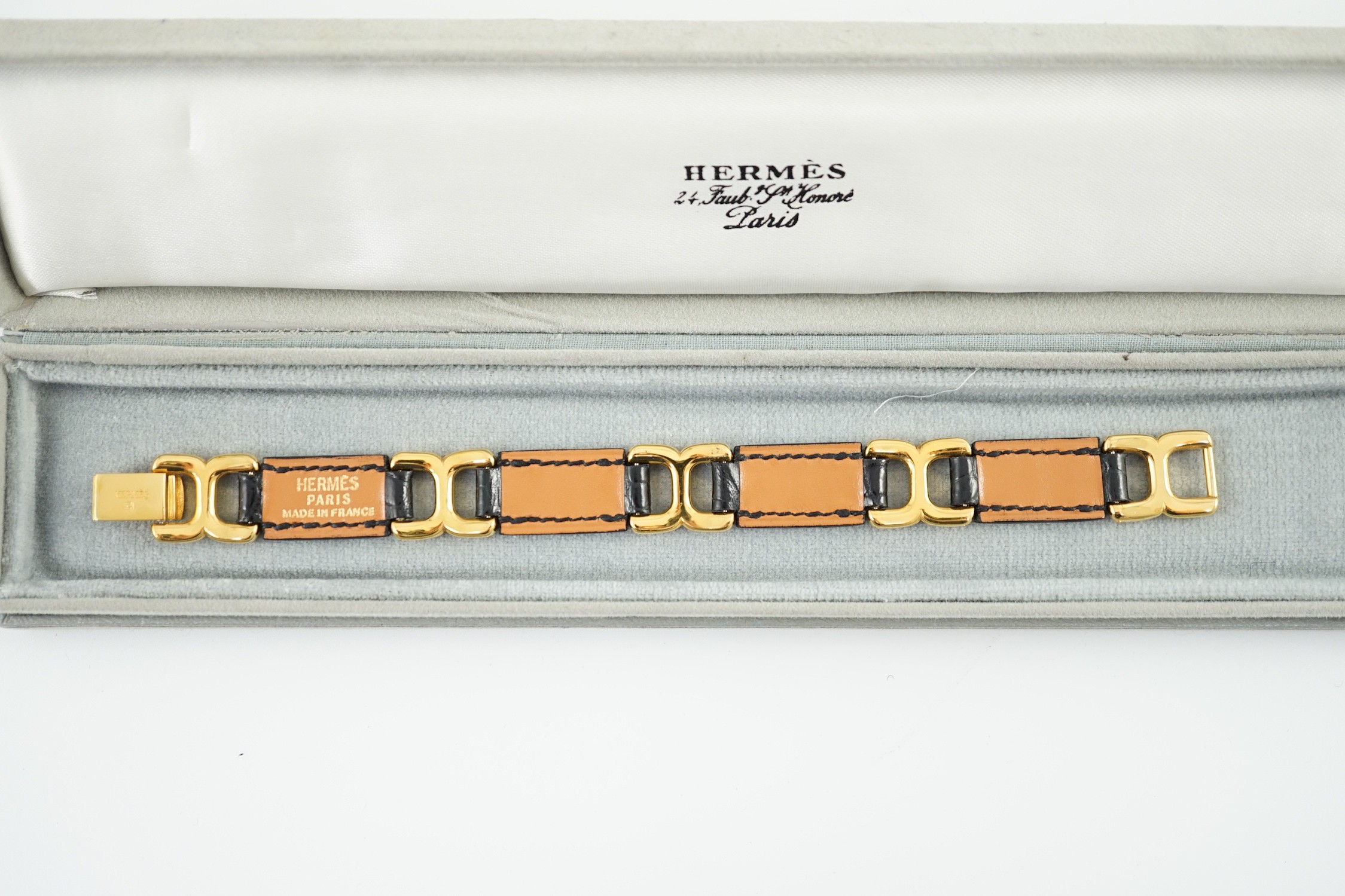 A boxed Hermes navy blue leather and gilt metal bracelet, 19cm.
